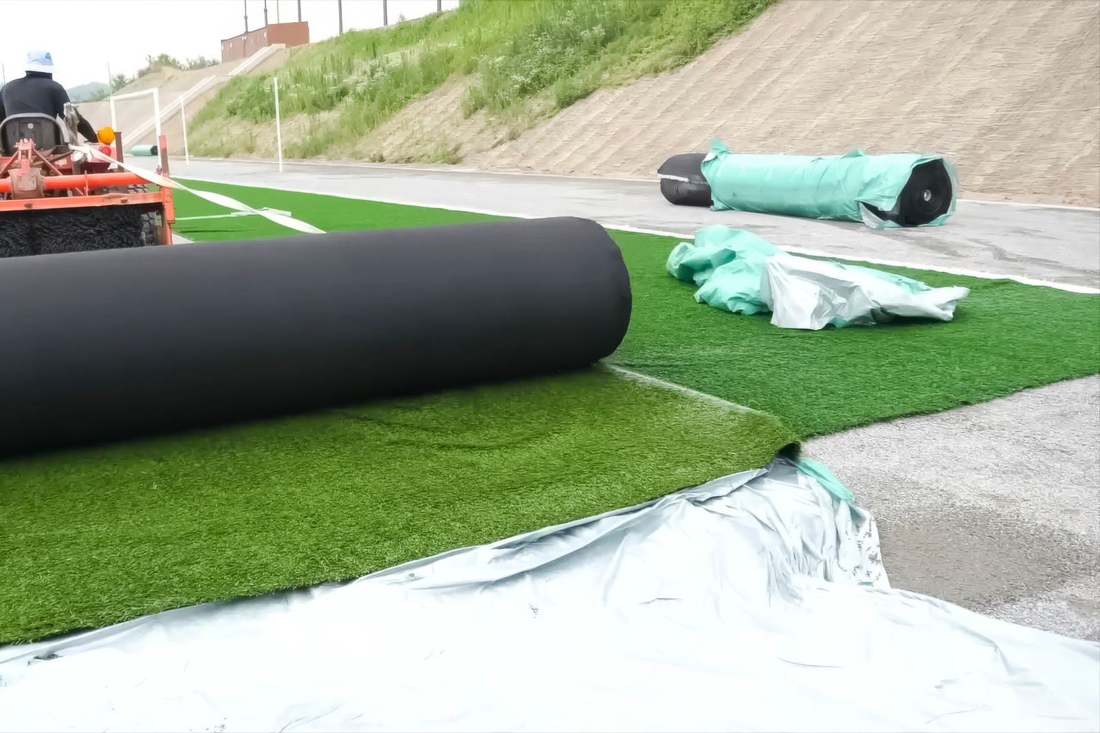 Crew installing fresh sod rolls on a prepared lawn in Chipley, Florida