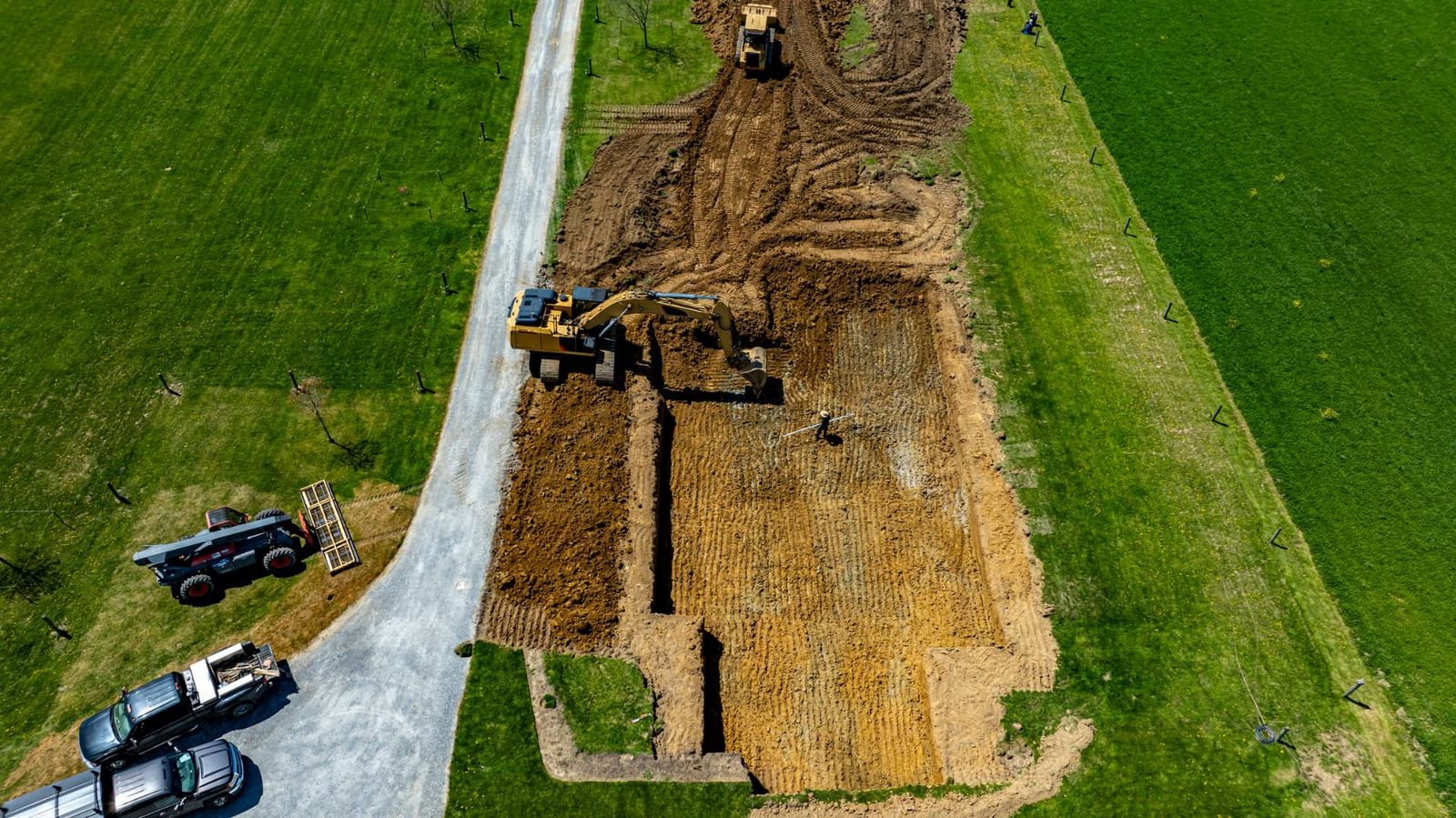 Graded and leveled building pad with survey stakes on rural land near Chipley, FL